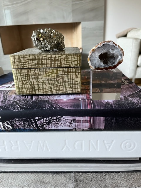 geode on acrylic base with books
