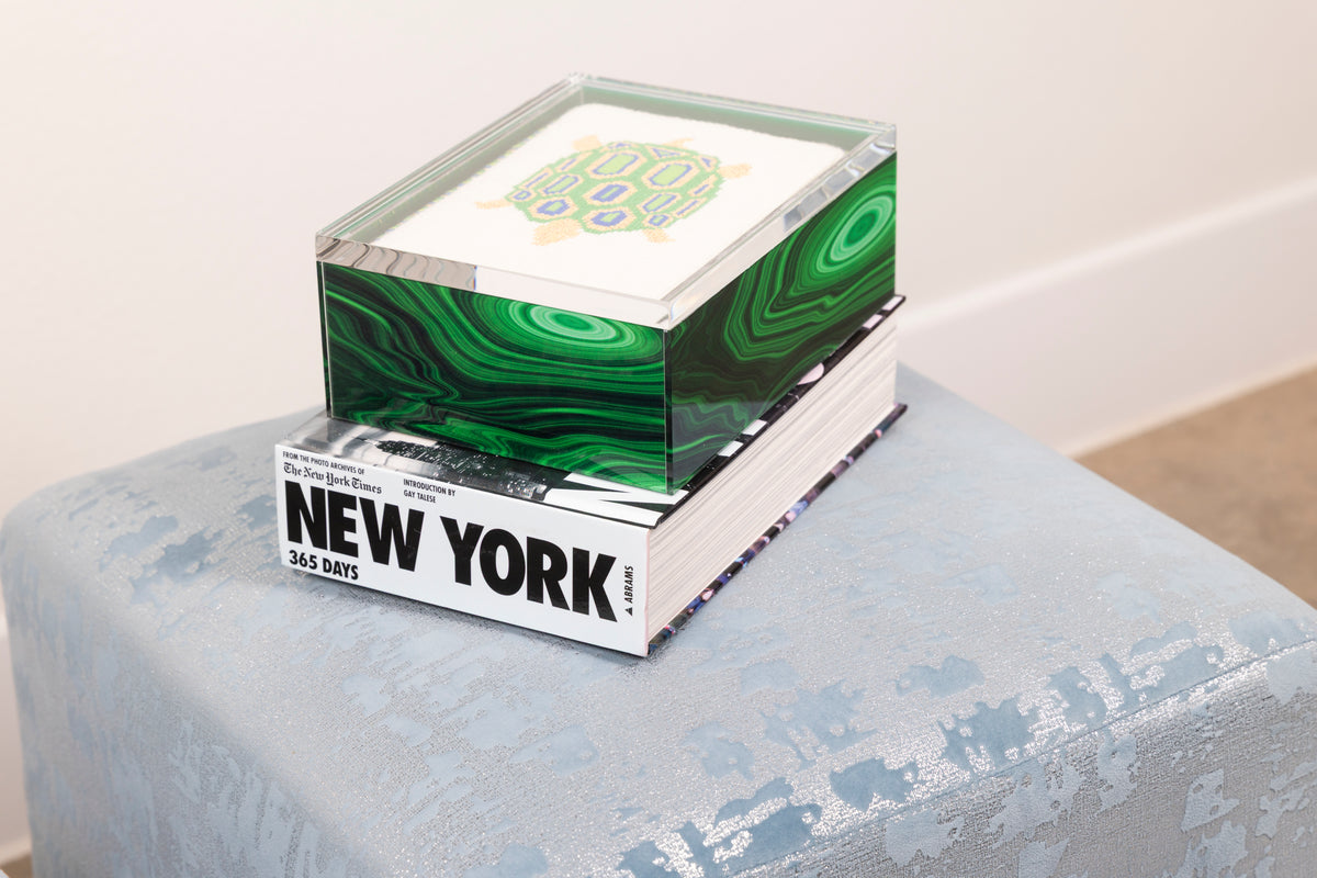 Malachite acrylic box displaying finished needlepoint in a lifestyle setting