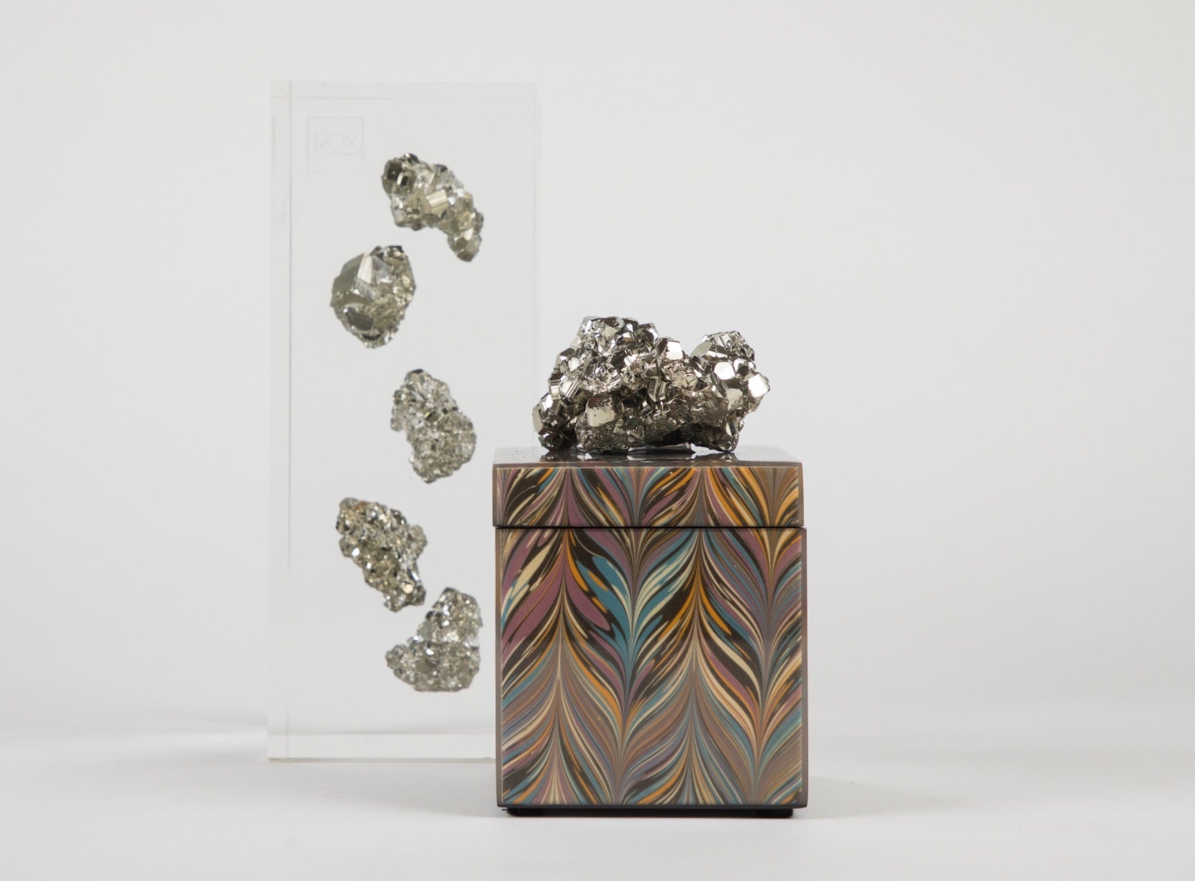 geodes gold floating in acrylic embedment  next to lacquer box with chevron pattern