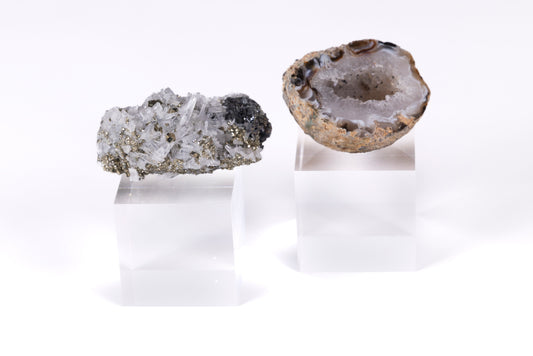 Two geological geodes on a white background