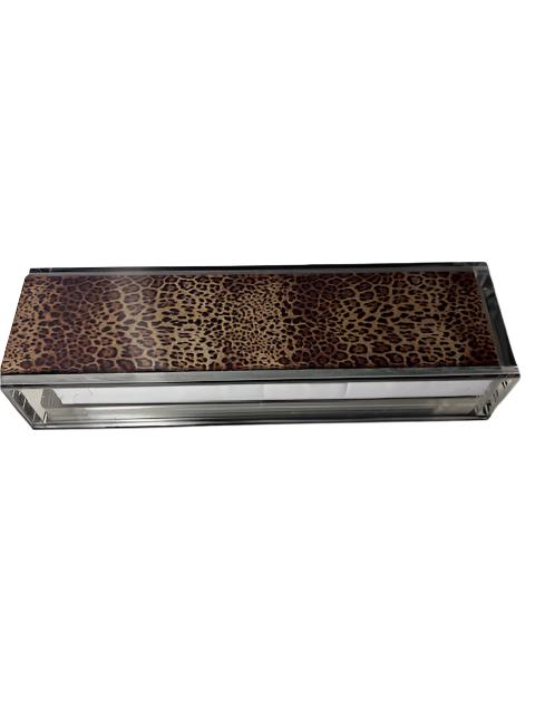 A leopard print Rummikub set in an acrylic case with tiles and racks visible.
