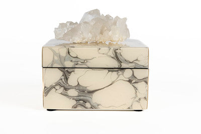 A gray marble box with a sparkly, lacquer finish, featuring a crystal-like decoration on top.