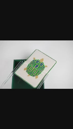 video of needlepoint canvas fitting into the malachite acrylic box after finishing. finishing product for needlepoint