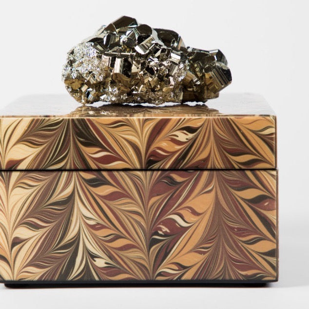 A decorative lacquer box with a geometric pattern, topped with a semi-precious crystal, providing a unique and luxurious gift option. desert rose pattern 