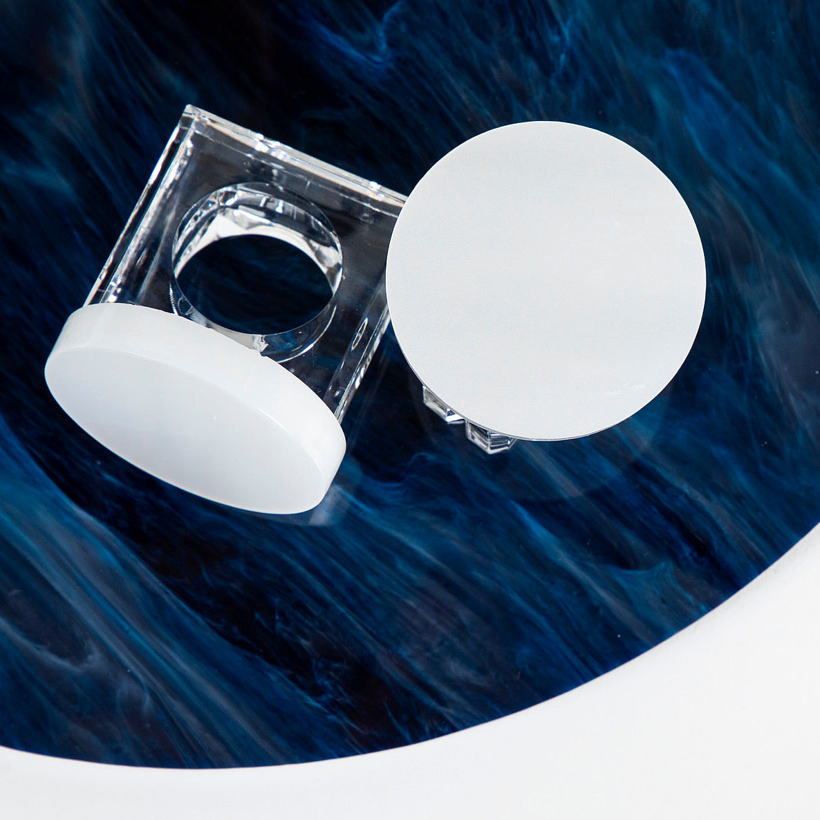 coastal blue acrylic placemat round with white acrylic round napkin rings 