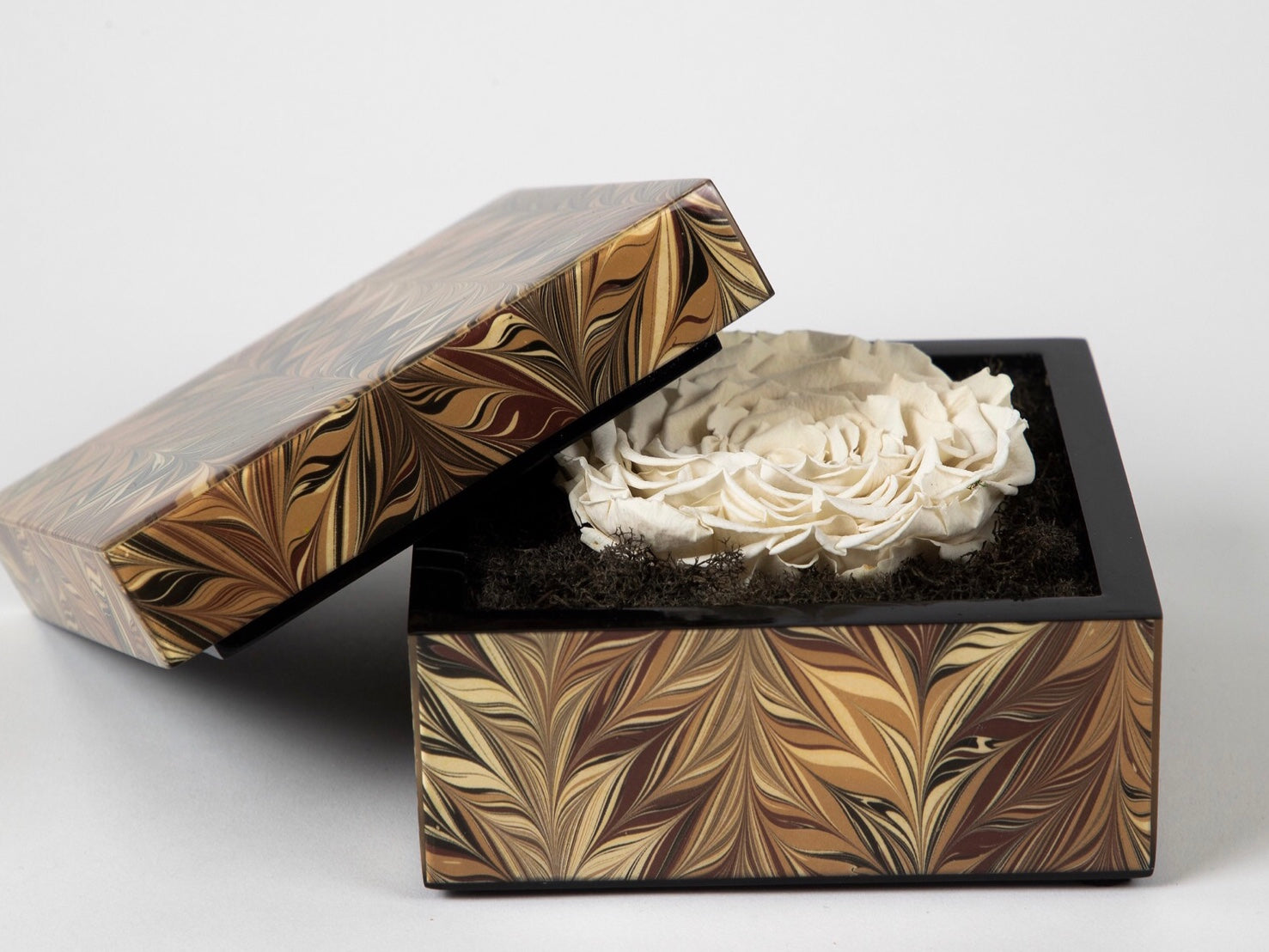 lacquer box with desert rose pattern and floral inside. 