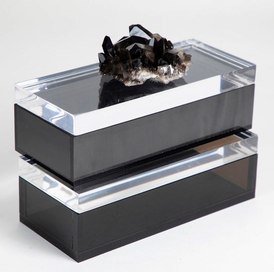 A marbled smoky black acrylic box with a semi precious crystal on top, featuring a removable lid and protective rubber feet.